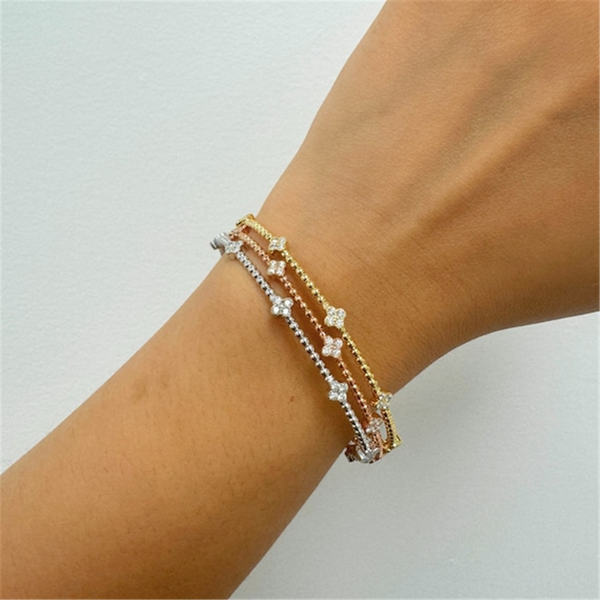 Sophisticated & Timeless Diamond Bracelets 14K Gold Two-Toned White & Yellow & Titanium Diamond Quatrefoil Flexible Bangle Bracelet - 0.35 CTW, Size 6.75 Inch